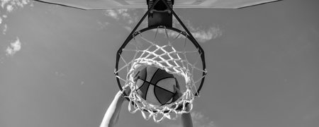 basketball ball dunk through net ring with hands, winning