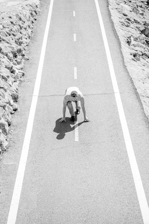 healthy lifestyle. mature man on road start. sport activity. full of energy. guy ready to run.