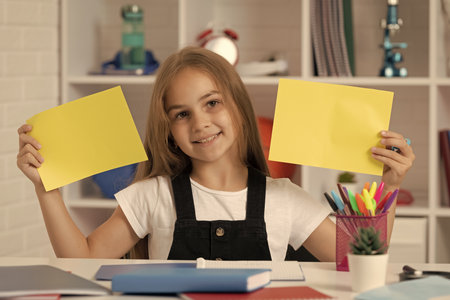 happy child hold paper in school classroom. copy spaceの写真素材