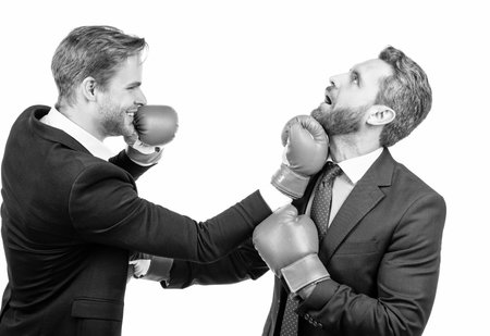Business partners competitors fight with boxing gloves in formalwear isolated on white, competitionの写真素材