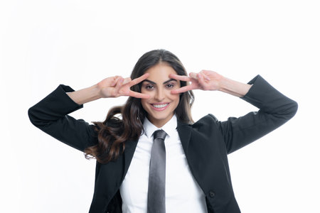 Business woman with victory sign. Happy positive funny businesswoman show victory v-sign gesture isolated on white background, studio portrait. Portrait of attractive funny crazy student.の写真素材