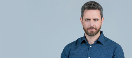 Bearded man in casual style shirt hold rangefinder photo camera on hand grey background,...