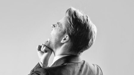 Professional broker man take fist hit in face during fighting grey background, punchの写真素材