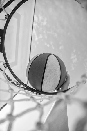 basketball player throws the ball into the hoop, closeup, sport success