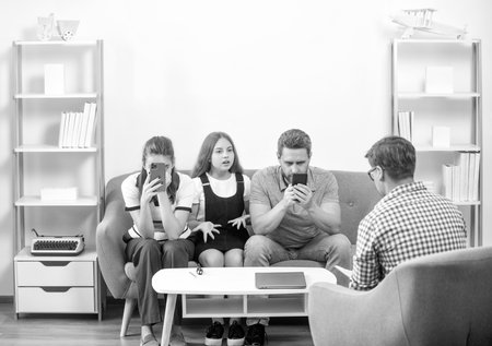 phone addicted father mother and child at family psychologist, therapyの写真素材