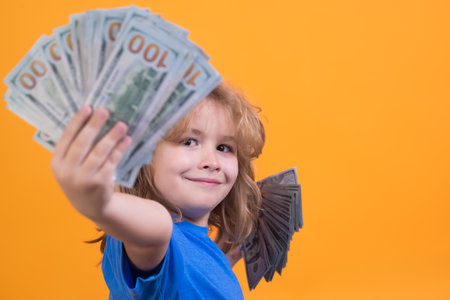 Rich child with dollars. Lottery cashback, win big money isolated yellow background.
