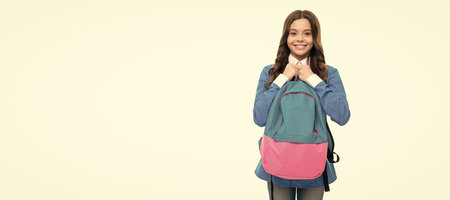 cheerful face of teen girl with long curly hair hold school bag isolated on white, back to school. Horizontal isolated poster of school girl student. Banner header portrait of schoolgirl copy space.の写真素材