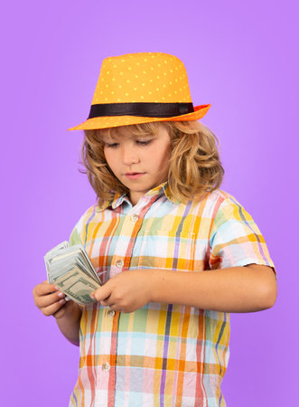 Cash money dollars bills. Kid showing money dollar bills, standing dreamy of rich against isolated studio background.の写真素材