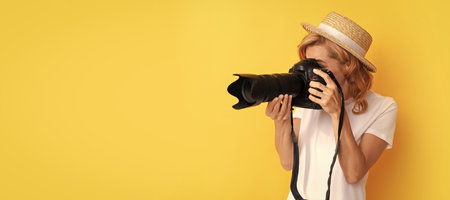 professional woman photographer with camera in straw hat making photo, photographing. Woman isolated...