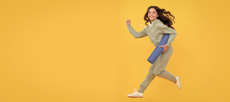 glad child in sportswear running with fitness mat. fit your body. sport teen girl training. Horizontal poster of isolated child face, banner header, copy space.の写真素材