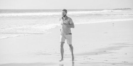 morning workout activity. healthy man running on beach. energetic summer.