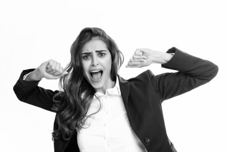 Screaming hate rage woman face. Excited female face. Emotional angry woman screaming on studio isolated background. Human emotions, expressive facial expressions. Panic and scream.の写真素材