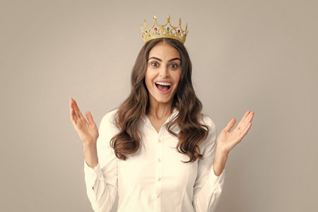 Amazing overjoyed woman queen wear golden crown, isolated gray background.の写真素材