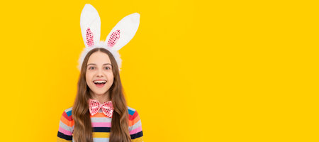 happy easter kid in bunny ears and bow tie on yellow background. Easter child horizontal poster. Web...