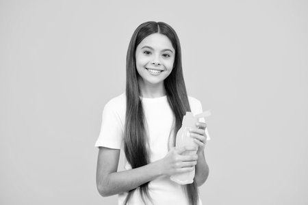 Girl teen hold water bottle. Water bottle and healthy life. Health and water balance. Drink and beverage concept. Happy teenager portrait. Smiling girl.の写真素材