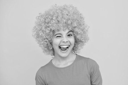 Funny face. Close up portrait of the cute clown girl.の写真素材