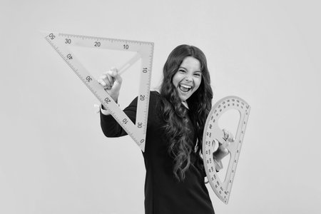 Excited face. Teenager school girl study math or geometry lesson, measure the size. Mathematics ruler for measuring. Amazed expression.の写真素材