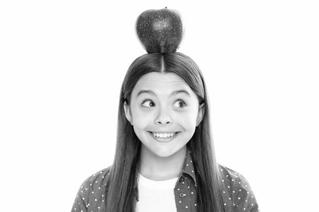 Fresh big red apple. Teenager girl hold apples on white isolated studio background. Child nutrition. Portrait of happy smiling teenage child girl.の写真素材