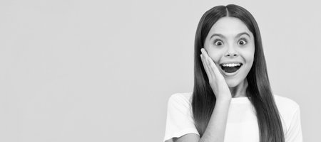 happy child girl hold big citrus fruit of yellow pummelo or pomelo full of vitamin, happiness. Child face, horizontal poster, teenager girl isolated portrait, banner with copy space.の写真素材
