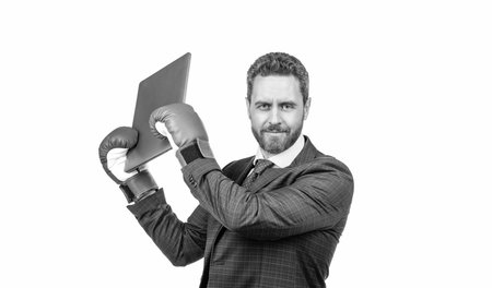 confident businessman man in suit and boxing gloves crash computer isolated on white, aggression