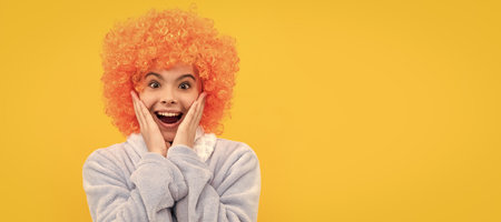 childhood happiness. birthday or pajama party. funny kid in curly clown wig. Funny teenager child on party, poster banner header with copy space.の写真素材
