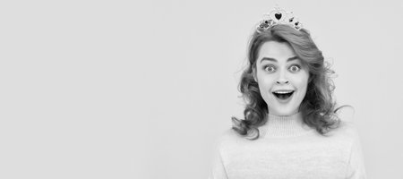 Woman isolated face portrait, banner with copy space. amazed redhead woman in queen crown, surprise.の写真素材