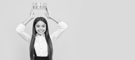 happy selfish teen girl in school uniform wear princess crown, selfishness. Child queen princess in crown horizontal poster design. Banner header, copy space.の写真素材