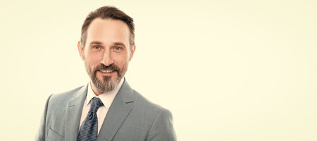 Man face portrait, banner with copy space. smilinng mature grizzled entrepreneur in businesslike suit isolated on white, charisma.の写真素材