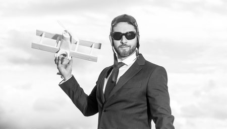 employee in suit and pilot hat launch plane toyの写真素材