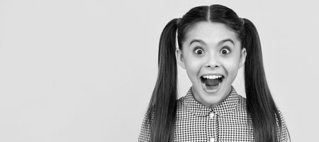 amazed teen girl. Child face, horizontal poster, teenager girl isolated portrait, banner with copy space.の写真素材