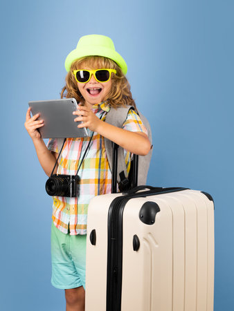 Child with travel suitcase on vacation. Kids travel and adventure concept.の写真素材