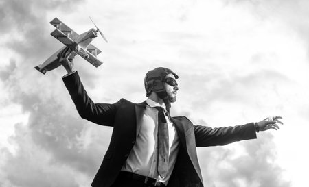 businessman in suit and pilot hat launch plane toy. ideasの写真素材
