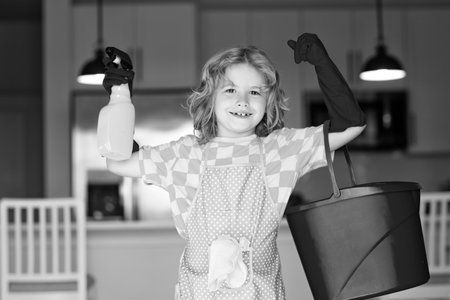 Child use duster and gloves for cleaning. Funny child mopping house. Cleaning accessory, cleaning supplies. Housekeeping and home cleaning.の写真素材