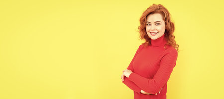 beautiful redhead girl face portrait smiling on yellow background, copy space, fashionの写真素材