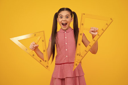Amazed teenager. Back to school. Teenager school girl on isolated background. School supplies. Excited teen schoolgirl.の写真素材