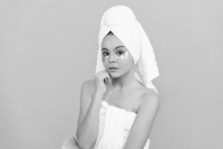 teen girl in shower towel with moisturizing patchの写真素材