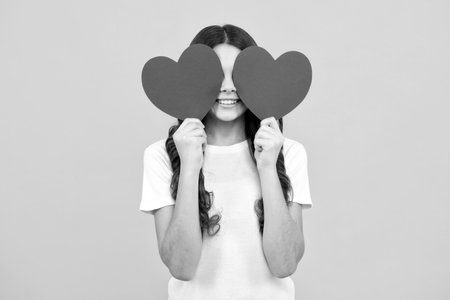 Happiness kids and love concept. Romantic lovely teen girl with red heart, world heart day, happy valentines day.の写真素材
