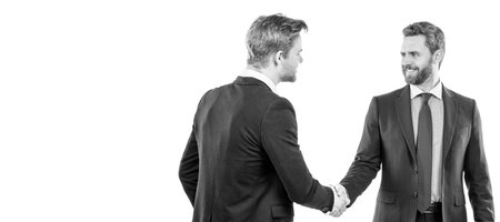 two businessmen colleagues shaking hands after successful business deal, welcome. Man face portrait, banner with copy space.の写真素材