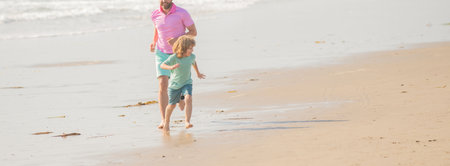 cropped father and son running on summer beach. family travel weekend and vacation.の写真素材