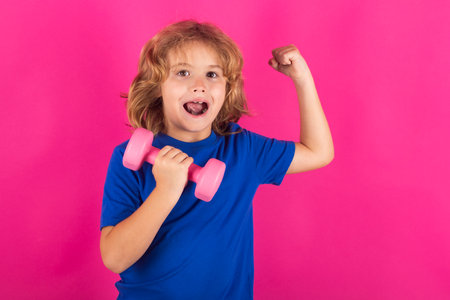 Sporty kids, studio isolated portrait. Sport child workout. Child exercising with dumbbells. Sporty child with dumbbell. Fit kids training.の写真素材