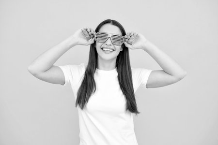Portrait of beautiful party woman in funny carnival glasses. Excited girl.の写真素材