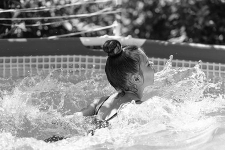 Girl child enjoy swimming in leisure pool on summer vacation, swimの写真素材