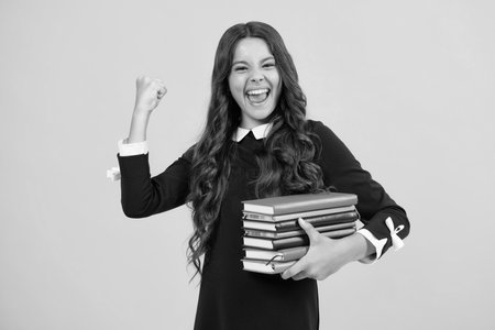 Excited face. Back to school. Portrait of teenage school girl with books. Children school and education concept. Schoolgirl student. Amazed expression, cheerful and glad.の写真素材
