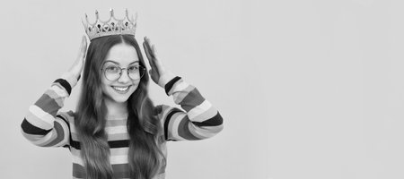 self confident queen. expressing smug. arrogant princess in tiara. cheerful proud child. Child queen princess in crown horizontal poster design. Banner header, copy space.の写真素材