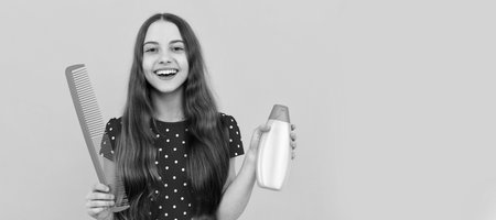 hairdresser. girl has wavy hairdo hold hairbrush. teen beauty hairstyle. frizz child portrait. Kid girl hair care, horizontal poster. Banner header with copy space.の写真素材