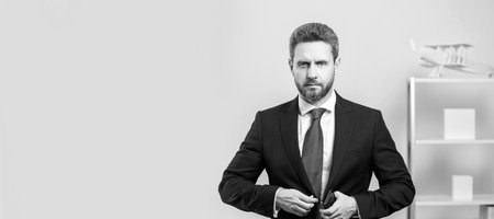 Man face portrait, banner with copy space. businessperson in suit at business office with phone.の写真素材