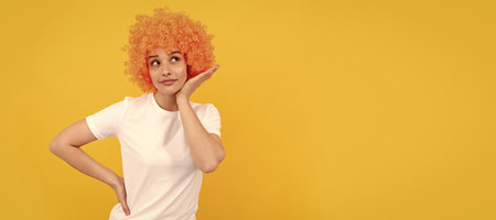 Woman isolated face portrait, banner with copy space. looking so cute. woman has orange hair. being a clown. april fools day. time for fun.の写真素材