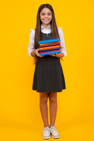 Teenager school girl with books isolated studio background.の写真素材