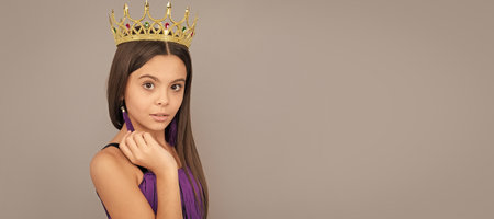 Look like a princess. Prom princess wear crown. Beauty queen grey background. Child queen princess in crown horizontal poster design. Banner header, copy space.の写真素材
