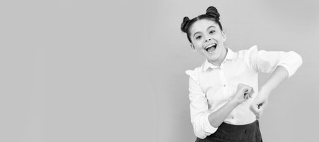 Fun first day of school. Happy schoolchild have fun. Primary school kid enjoy dancing. Child face, horizontal poster, teenager girl isolated portrait, banner with copy space.の写真素材